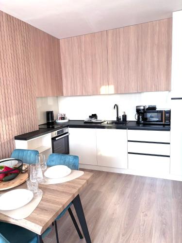 a kitchen with a table and chairs in a kitchen at Sorrento E 4 4 Sveti Vlas in Sveti Vlas