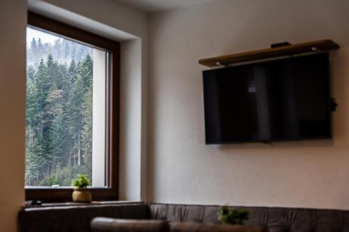 a living room with a couch and a large window at Vila Hrastnica in Škofja Loka