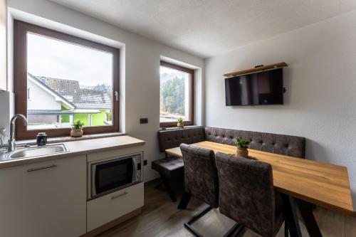 a kitchen and dining room with a table and chairs at Vila Hrastnica in Škofja Loka
