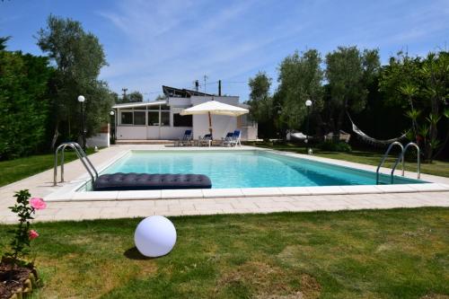 a swimming pool in the yard of a house at Villa MEMA in Bisceglie