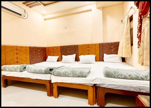 two twin beds in a room at Near Mahakal Temple Hotel P - LANDMARK ! Ujjain,Near Railway station ,Fully Air conditioned Rooms And Spacious, with Wi-Fi , BEST HOTEL IN UJJAIN in Ujjain