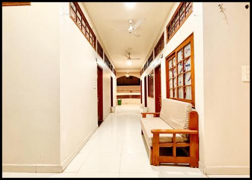 a hallway of a house with a couch and a table at Near Mahakal Temple Hotel P - LANDMARK ! Ujjain,Near Railway station ,Fully Air conditioned Rooms And Spacious, with Wi-Fi , BEST HOTEL IN UJJAIN in Ujjain