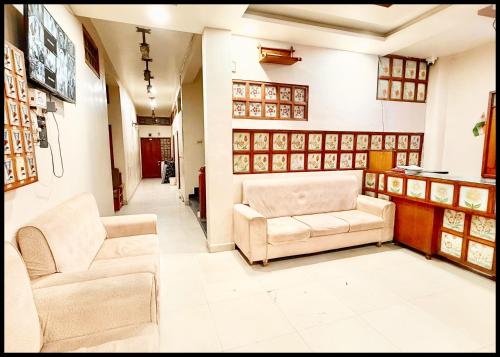a living room with two chairs and a couch at Near Mahakal Temple Hotel P - LANDMARK ! Ujjain,Near Railway station ,Fully Air conditioned Rooms And Spacious, with Wi-Fi , BEST HOTEL IN UJJAIN in Ujjain