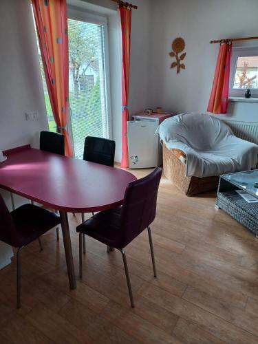 a living room with a table and chairs and a bed at Apartmány Kojčice 