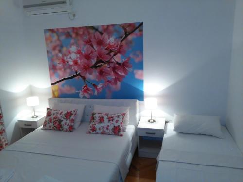 a living room with two white beds and two lamps at Villa Jelena in Trebinje