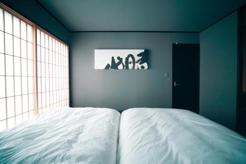 a bedroom with a white bed with a window at ERA1220 Shinjuku,3bedroom,8people in Tokyo