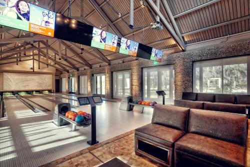 a bowling alley with couches and a ping pong table at River View 3 Bedroom Wilson Village Home 70 in Bluffton