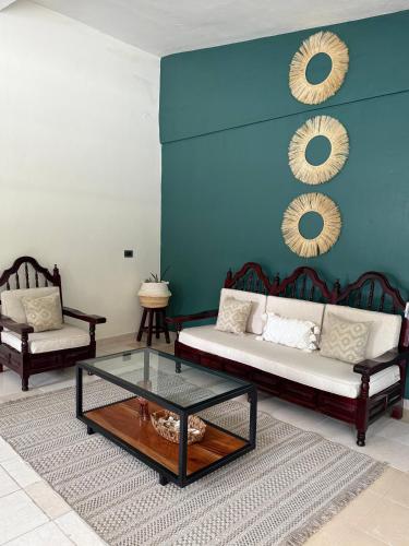 a living room with a couch and a coffee table at Lunas Apartment in Palenque
