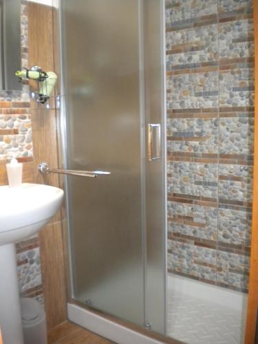 a shower with a glass door in a bathroom at B&B del Centro in Capo dʼOrlando