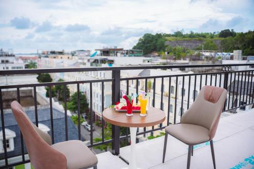 a table and chairs on a balcony with a view at Crystal Holiday Ha Long Hotel in Ha Long