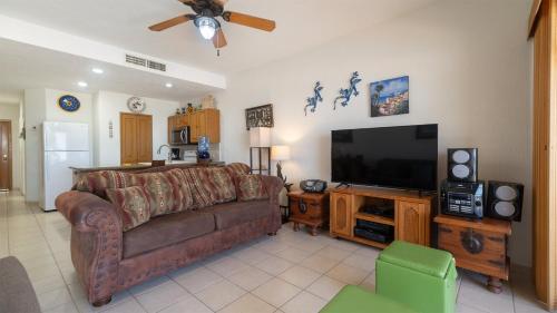 a living room with a couch and a flat screen tv at Laughing Seagull Lovely Oceanfront Condo in Puerto Peñasco