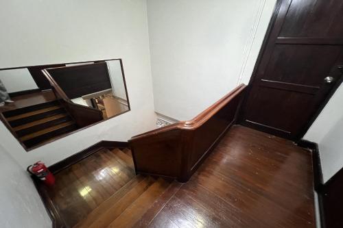 a stairway with a mirror and a stair case at Orchid Hostel in Bangkok