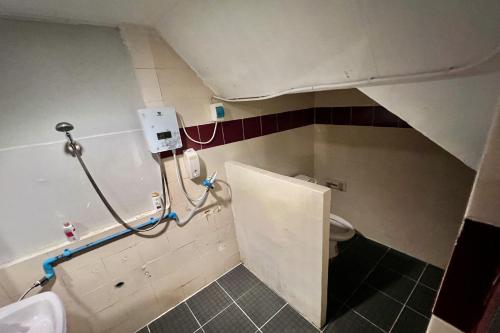 a bathroom with a sink and a toilet at Orchid Hostel in Bangkok