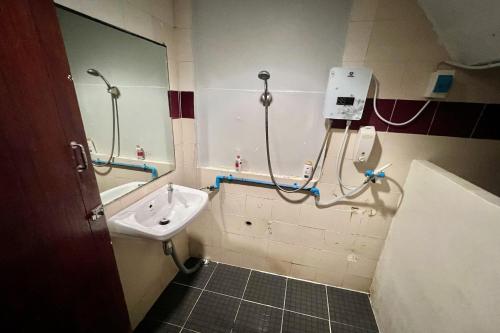 a bathroom with a sink and a bath tub at Orchid Hostel in Bangkok