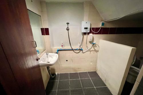 a bathroom with a sink and a shower in it at Orchid Hostel in Bangkok