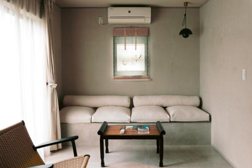 a couch in a room with a table and a window at ERA1220 Shinjuku,3bedroom,8people in Tokyo