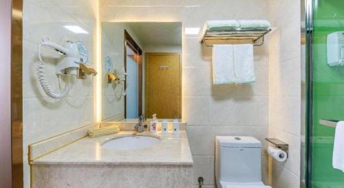 a bathroom with a sink and a toilet at GreenTree Inn Nantong University Industrial Expo City Express Hotel in Nantong