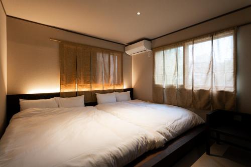 a large white bed in a room with a window at ERA1220 Shinjuku,3bedroom,8people in Tokyo