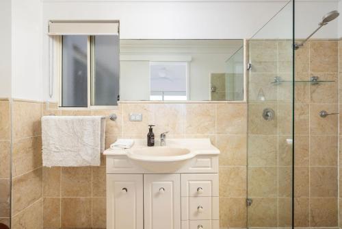 a bathroom with a sink and a shower at Hear the waves watch the whales Anna Bay in Anna Bay