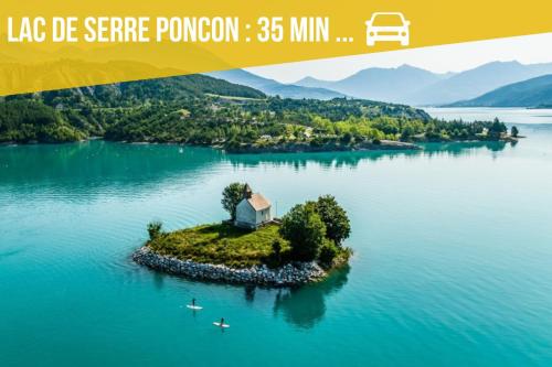 an island in the water with a house on it at L'Aiglon Studio cocon au coeur de Gap in Gap
