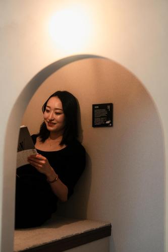 a woman standing in a hallway holding a paper at ERA1220 Shinjuku,3bedroom,8people in Tokyo