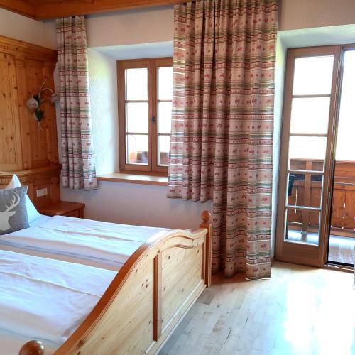 a bedroom with a bed and two windows at Kasparbauer in Sankt Michael im Lungau