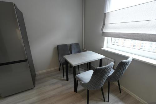 a small table and chairs in a room with a window at Kuncų apartments, self-check in, free parking, cozy in Klaipėda