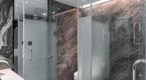 a bathroom with a shower with a glass door at Nanning Prince Hotel in Nanning