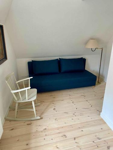 a blue couch and a chair in a room at Charming Townhome Near Beach And Square in Ærøskøbing