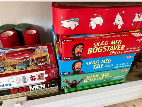 two boxes of toys on a shelf in a store at Charming Townhome Near Beach And Square in Ærøskøbing