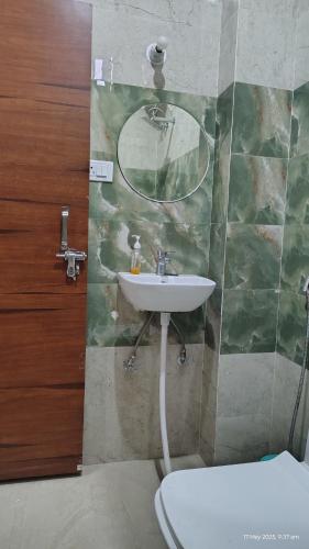 a bathroom with a sink and a toilet at Hotel Shree Mayakunj in Rāe Bareli