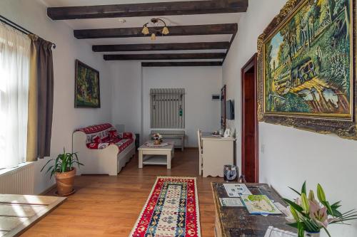 a living room with a couch and a rug at Taschler Haus in Sighişoara