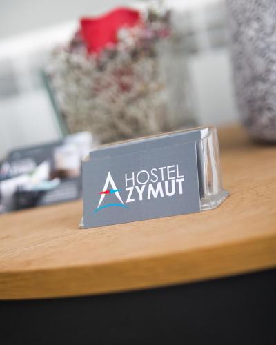 a sign for a hospital xylunit on a table at Hostel Azymut in Września