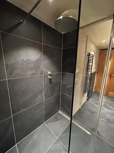 a shower with a glass door in a bathroom at Le Pacheu in Les Crosets