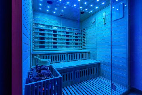 a blue room with a sauna with blue lights at PerfectSpa Wellness Apartment in Humenné