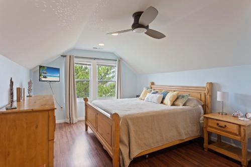 a bedroom with a bed and a ceiling fan at 6090 - Seas The Day NH in Nags Head