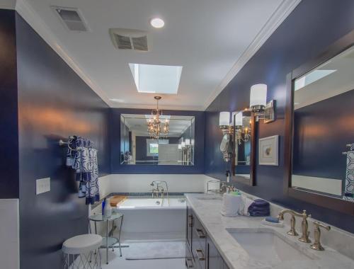 a bathroom with two sinks and a bath tub at 5 Bed Sleeps 12 with Water Views in Fripp Island