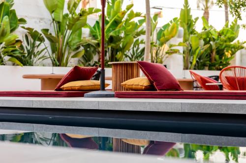 a table with red and yellow pillows on it at Palazzo Piccinno in Parabita