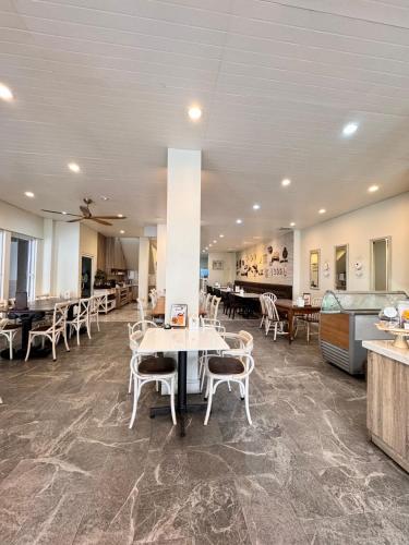 a dining room with tables and chairs in a building at Lithai Guesthouse in Phitsanulok