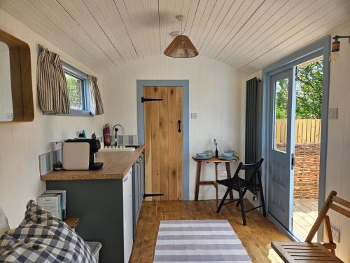 a small kitchen with a counter and a table at Wee Haven in Inverkeithing