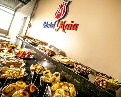 a bakery with a bunch of different types of pastries at Hotel Maia in Betim