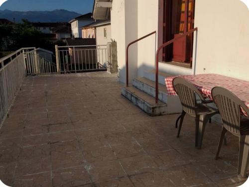 a patio with a table and chairs on a balcony at appartement Oloron in Oloron-Sainte-Marie