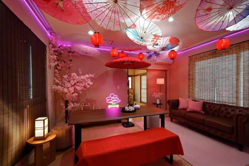 a living room with umbrellas hanging from the ceiling at Otter Stay - Nagoya Castle in Nagoya
