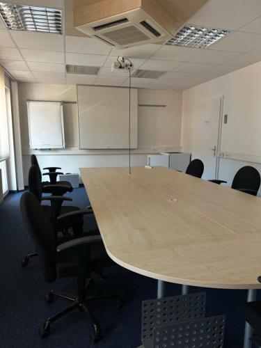 a conference room with a large wooden table and chairs at Stube Hotel und Gasthaus in Nordrach