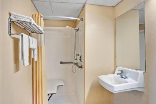 a bathroom with a sink and a shower at Days Inn by Wyndham Louisville Airport Fair and Expo Center in Louisville