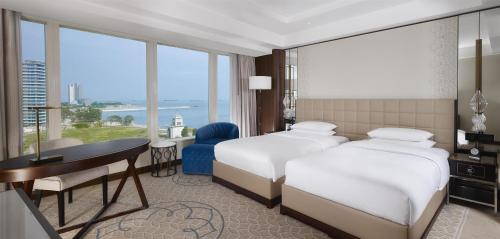 a hotel room with two beds and a desk at Hyatt Regency Istanbul Atakoy in Istanbul