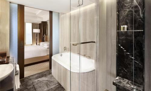 a bathroom with a tub and a sink and a shower at Hyatt Regency Istanbul Atakoy in Istanbul