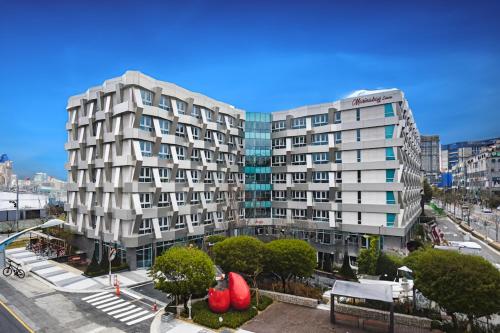 an aerial view of two tall buildings in a city at Sokcho Marina Hotel in Sokcho