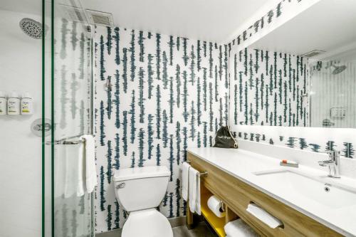 a bathroom with a toilet and a shower at La Quinta by Wyndham Lexington Park - Patuxent in California