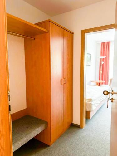 a room with a closet and a bedroom with a bed at Stube Hotel und Gasthaus in Nordrach